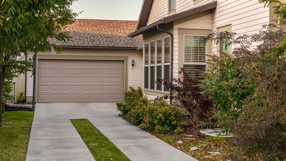 artificial turf installed between concrete pavers to create a modern-looking driveway in Mesa, AZ